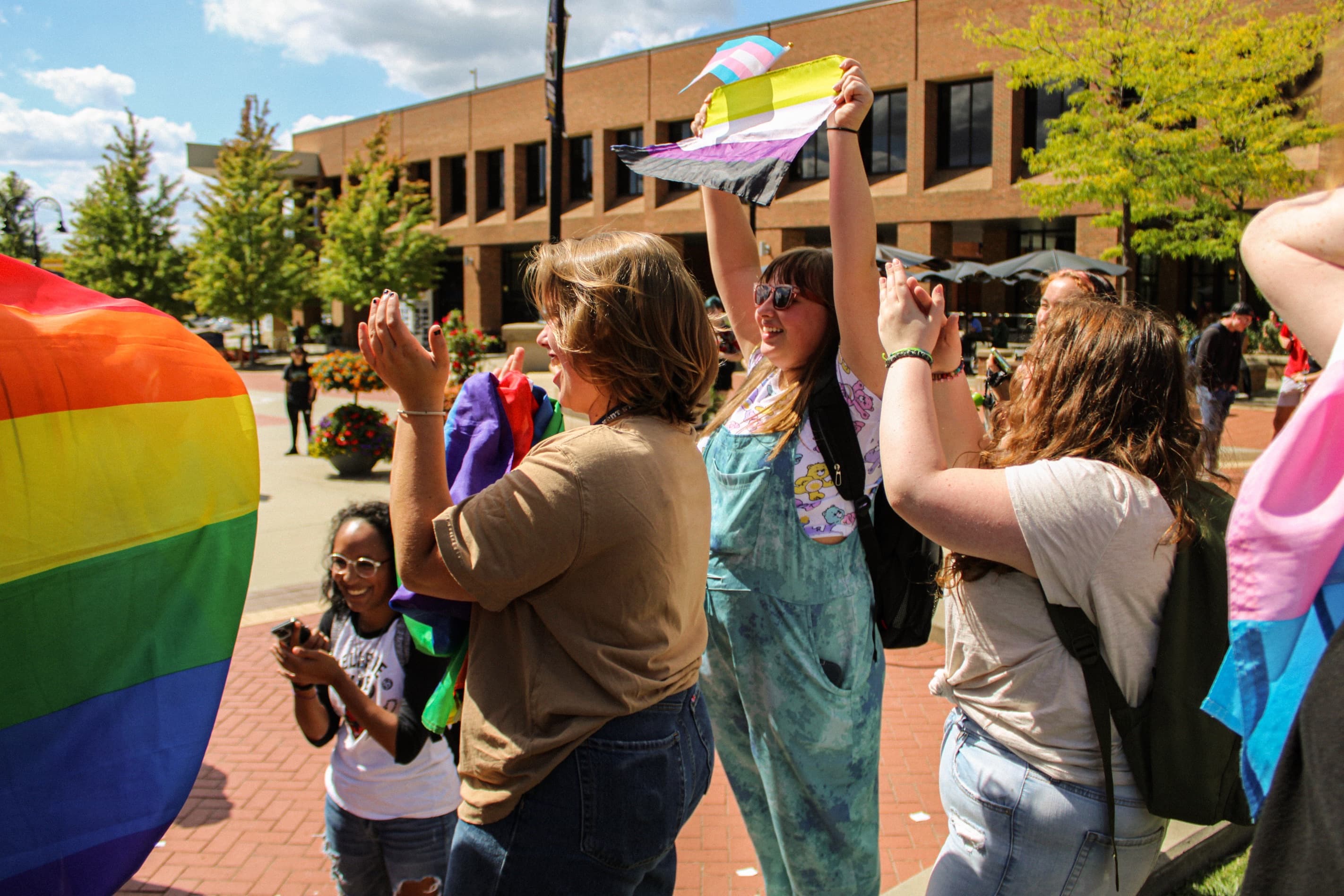 Outdoor pride celebration with rainbow flags in Akron